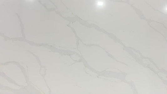 Calacatta Platinum quartz slab with a white background which is enhanced by grey and gold veining.