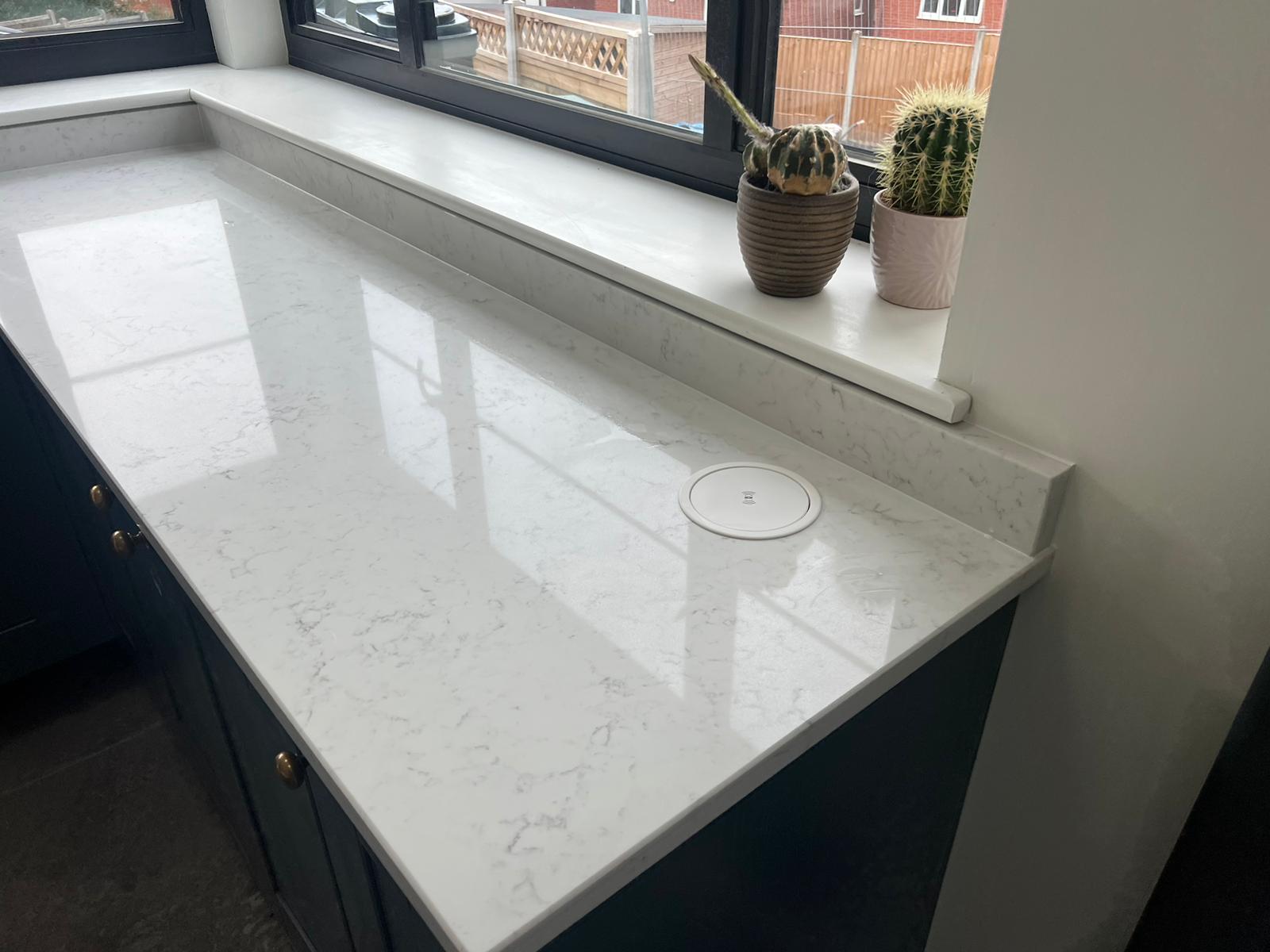 Carrara White quartz kitchen worktop with a soft white hue and smoky grey veins.