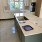 Calacatta Aurous quartz kitchen worktops with a cool white base with vivid gold and subtle grey veining intermixed elegantly.