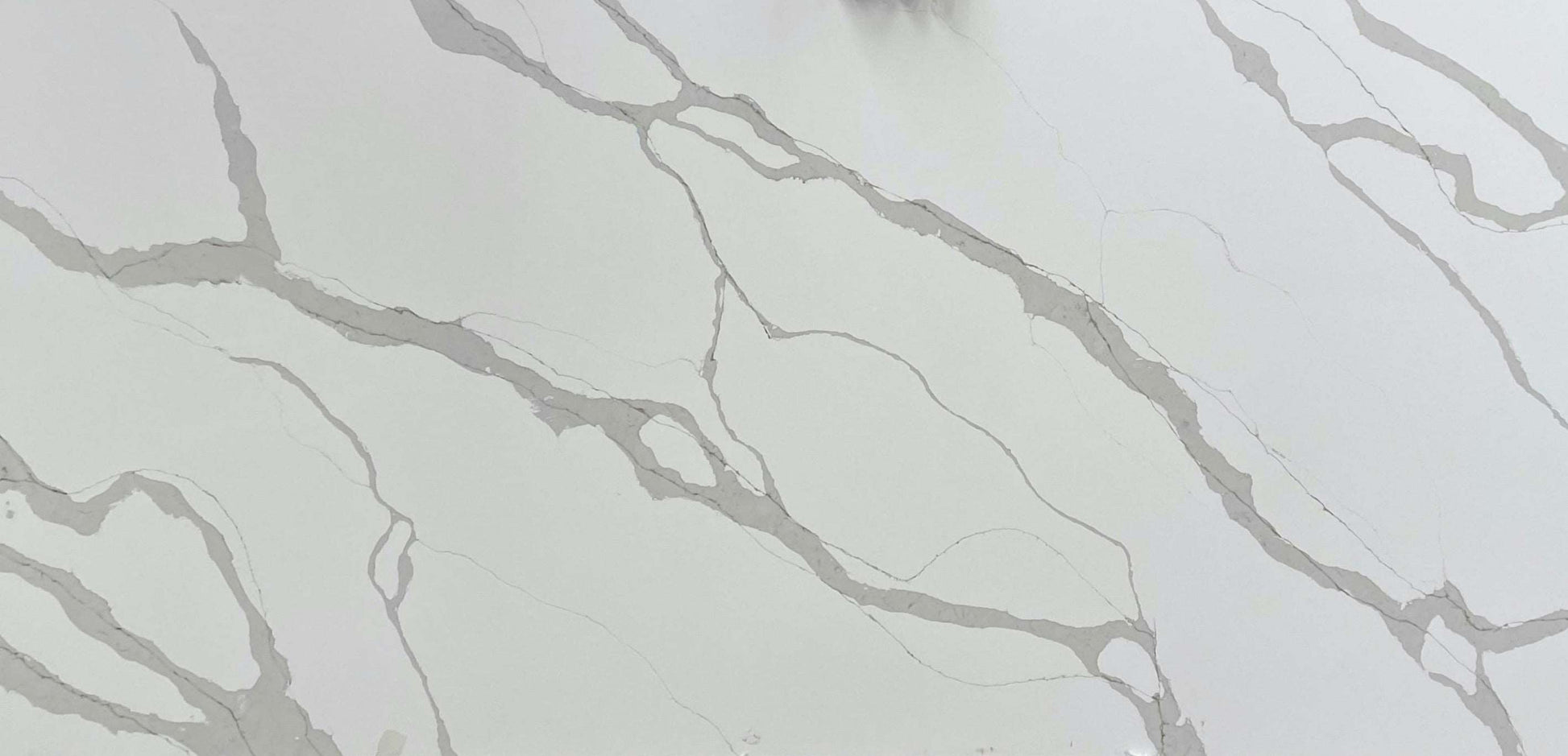 Calacatta Light quartz slab with a light background adorned by a combination of thin and thick grey veins.