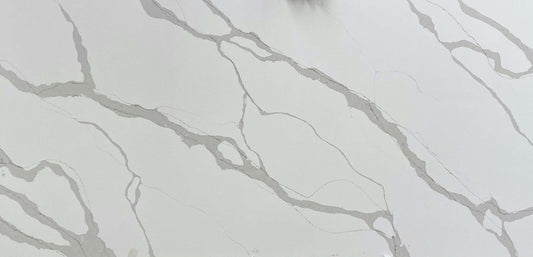 Calacatta Light quartz slab with a light background adorned by a combination of thin and thick grey veins.