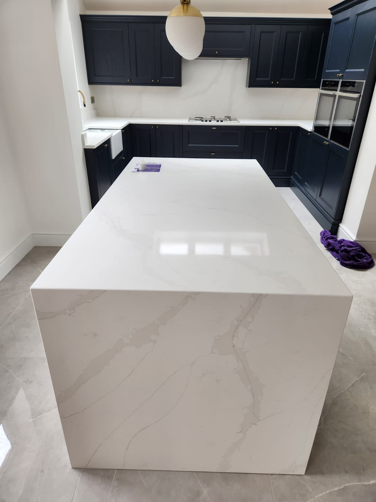 Calacatta gold quartz kitchen worktops with grey veins married with delicate gold veins throughout the slab on a white background.