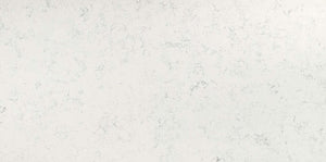 Carrara White quartz slab with a soft white hue and smoky grey veins.