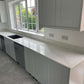 Fugen Calacatta Oro marble effect Quartz kitchen worktops with soft grey veining and gold veins running through it.