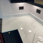 Fugen Calacatta Oro marble effect Quartz kitchen worktops with soft grey veining and gold veins running through it.