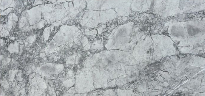 A close-up image of a grey printed quartz surface with unique veining.