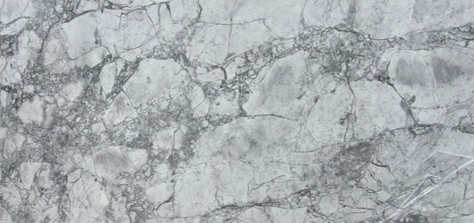 A close-up image of a grey printed quartz surface with unique veining.