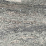 Branco Piracema patterned granite slab with waving colours of blue, grey and lighter colours.