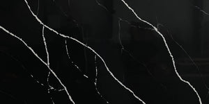 Black Marquina quartz slab, black marble-look quartz with white veining.