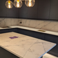 Modern kitchen with PQS Santorini quartz worktops and pendant lights