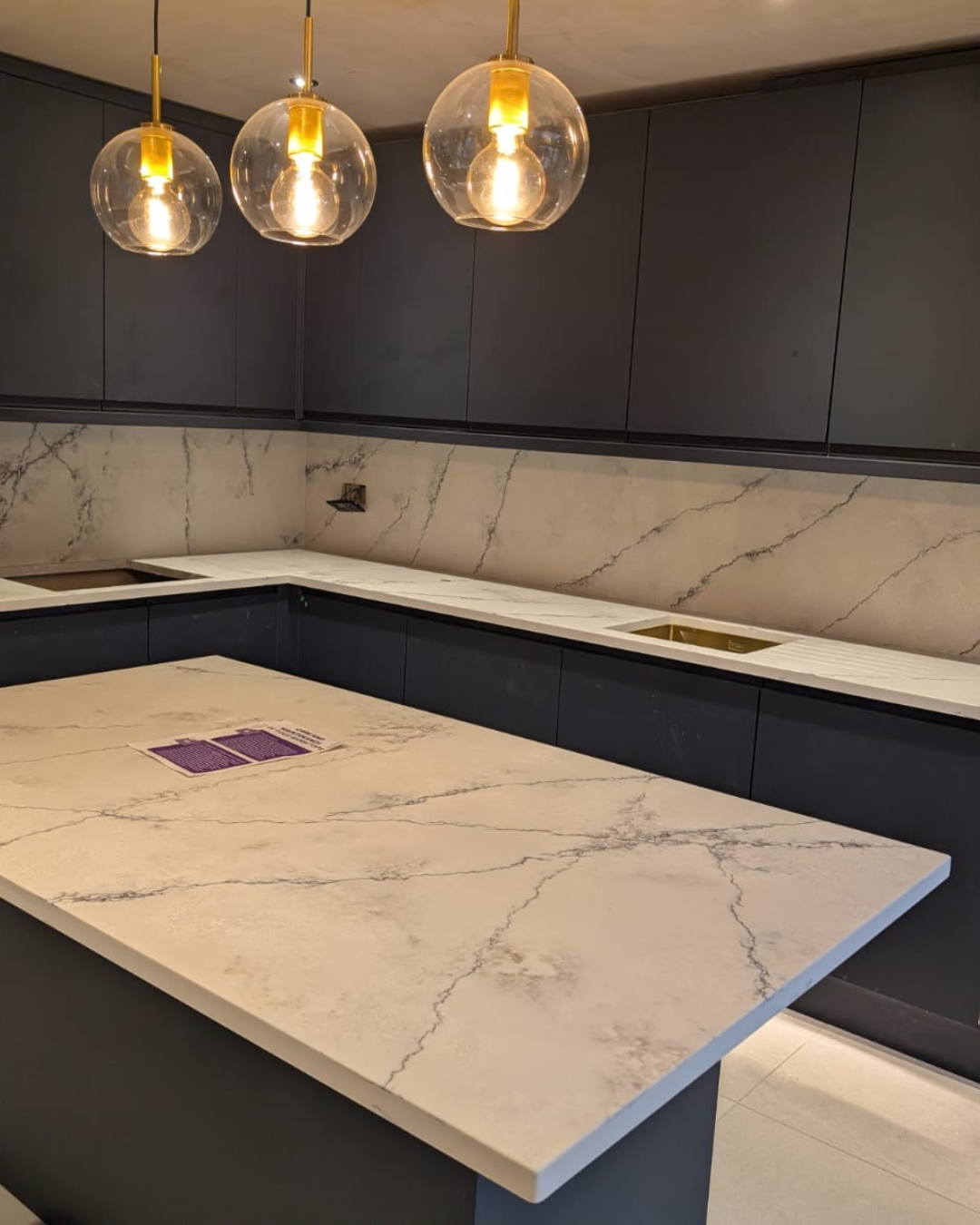 Modern kitchen with PQS Santorini quartz worktops and pendant lights