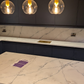 Luxury kitchen with Santorini quartz worktops featuring blue-tinted veins inspired by Carrara marble.