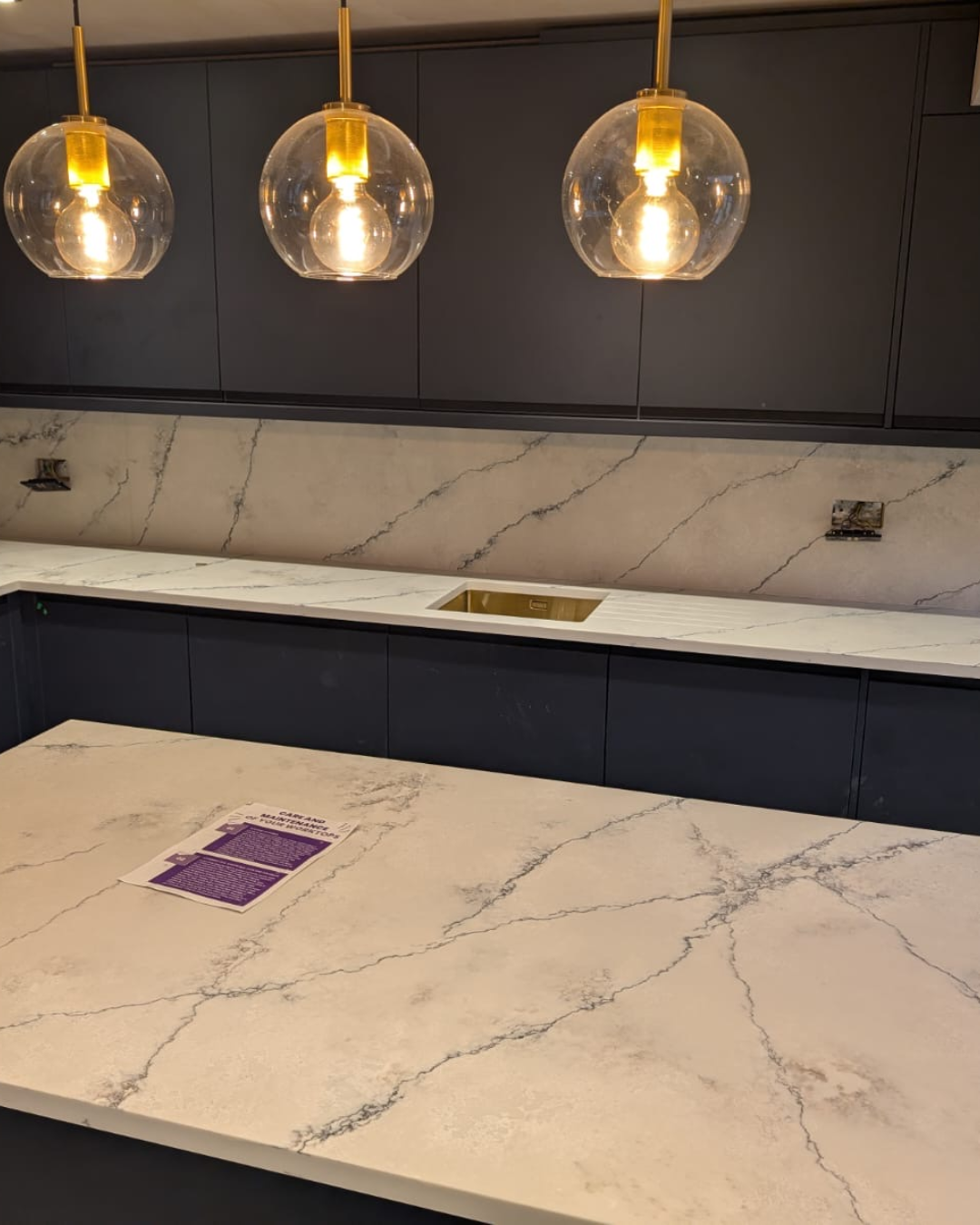 Luxury kitchen with Santorini quartz worktops featuring blue-tinted veins inspired by Carrara marble.