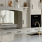 Fugen Calacatta Oro marble effect Quartz kitchen worktops with soft grey veining and gold veins running through it.